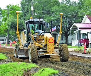 A CONSTRUCTION CREW from Texas Materials Group continues their road and drainage work on F.M. 975 on Monday, July 7, in this TxDOT project. Work is being done from State Highway 21 West to the UPR bridge rail with completion set for the spring of 2026, TxDOT said.