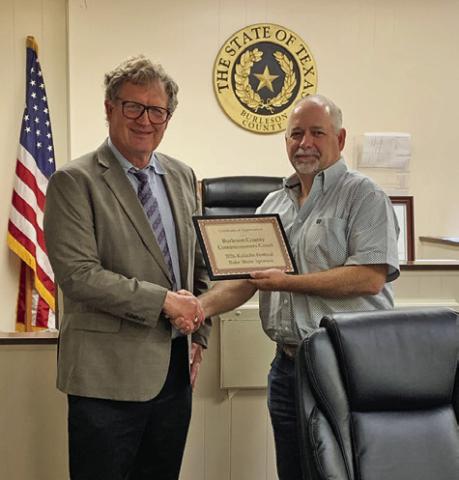 BRUNO SHIMEK PRESENTS County Judge Keith Schroeder with a certificate recognizing the commissioners court as a sponsor of the Kolache Festival Bake Show. Photo courtesy of Holly Narro