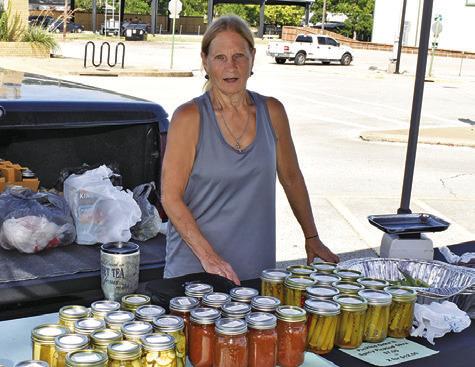 VICKIE DASH DISPLAYS her canned goods for sale on Saturday at the Farmers Market.