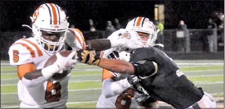 CALDWELL’S NICOLAS JOHNSON moves past this Giddings defender as Logan Knesek assists. The Hornets lost 21-7 in their district opener and face La Grange this week. -- Tribune photo by Roy Sanders