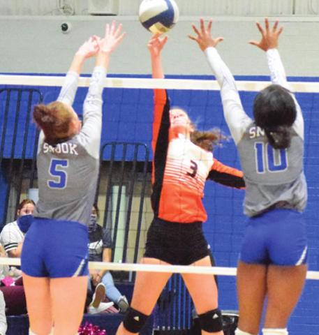 SOMERVILLE’S EMMA KOVASOVIC hits the ball between Snook’s Kenzie Kmiec and Jaivan Stringfellow during the Lady Yeguas-Lady Jays match last Tuesday. -- Tribune photo by Denise Hornaday