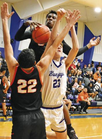 SOMERVILLE PLAYERS GAVIN Williams and Keith Crawford and Snook’s Josh Green fight for the ball in the Friday game.