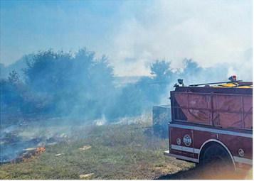 SOMERVILLE AND SNOOK volunteer firefighters battle this blaze off F.M. 1361. Photo courtesy of Snook Volunteer Fire Department