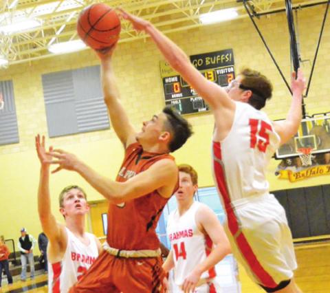 CALDWELL’S BOBBY LEROUAX takes a shot despite some heavy pressure from Bellville defenders last Friday in Giddings. The Hornets won the second-place playoff game 59-53.