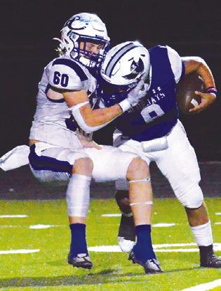 SNOOK’S JACOB Castaneda fights past this Falls City defender in last Friday’s game in Snook. Snook lost 28-0 and faces Yorktown this Friday, Oct. 27, in Yorktown.