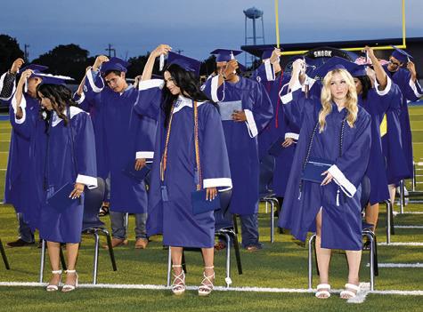 SNOOK HIGH SCHOOL graduates move their tassels on Friday at the commencement ceremony, signifying that they have graduated.