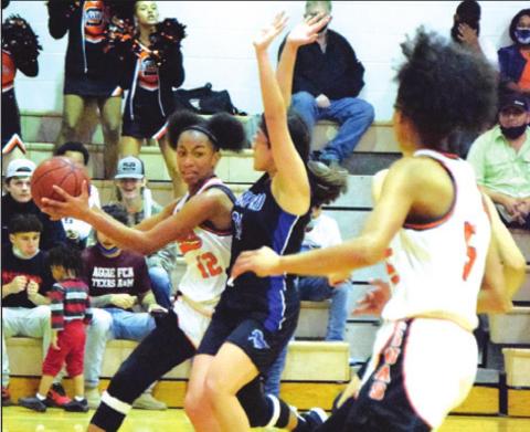 SOMERVILLE’S RA’MAYA Carter looks to pass the ball to Destiny Vela during the Lady Yeguas’ win over Mumford last Tuesday night.