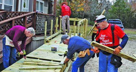 VOLUNTEERS, INCLUDING MEMBERS of the Caldwell Men’s Lions Club, build this ramp last Thursday on Park Road 57.