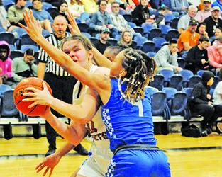 RILEY BROADDUS tries to find the basket as Anaya Fowler defends during the Caldwell-New Tech game last Tuesday night.