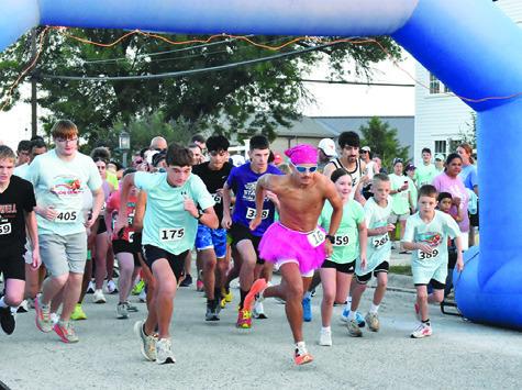 SPENCER ELLIS, CENTER, leads the pack from the starting line of Saturday’s Kolache Krunch 5K. Ellis won the race with a time of 17:25. Tribune photo by Roy Sanders