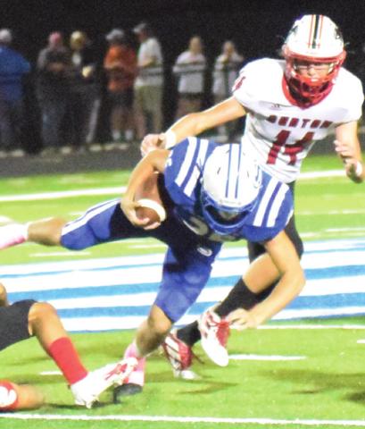 SNOOK’S JORDAN PRICE gets tripped up by the Burton defense during last week’s Bluejays’ home game. -- Tribune photo by Denise Squier