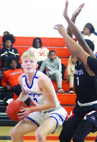 LIAM ZEQUEIRA of Snook prepares to shoot against the Brazos Cougars in the Schulenburg Tournament. -- Photo by Darrell Vyvjala of the Schulenburg Sticker