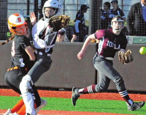 EMMA KOVASOVIC slams into the Iola catcher to score during the Lady Yeguas’ 23-17 win last week. -- Tribune photo by Denise Squier