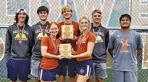 CALDWELL SENIOR TENNIS players proudly display the boys teams’ district champion plaque and girls teams’ district runner-up plaque at last week’s District Tennis Tournament in Caldwell.