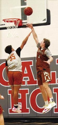 CALDWELL’S CLAYTON FRAYLEY takes a shot as Harrison Novak defends in the alumni scrimmage in Caldwell on Tuesday, Nov. 11.