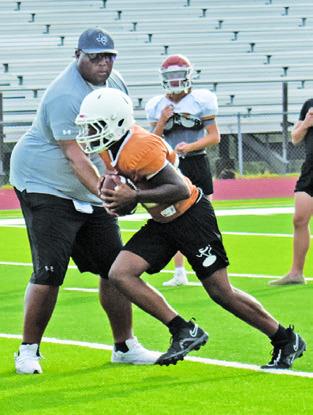 THE CALDWELL HORNETS work on their running game at Monday’s practice.