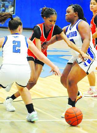 KARYS ELLIS dribbles through two Lady Mustangs during the Somerville-Mumford game last Friday night in Mumford. Tribune photo by Denise Squier