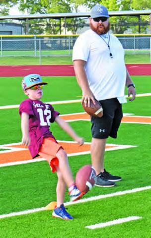PUNTING SKILLS are taught last Thursday at the Hornet football camp at CHS Stadium.