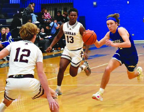 BRETT WITHEM OF Snook moves the ball down court against Vanderbilt Industrial. Snook lost 41-30. Tribune photo by Roy Sanders