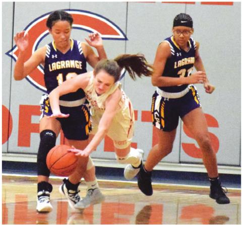 CALDWELL’S KATE URBANOVSKY trips over La Grange’s Kailee Jones during Tuesday night’s game at Hornet Gym. Number eight La Grange won the game. -- Tribune photo by Denise Hornaday