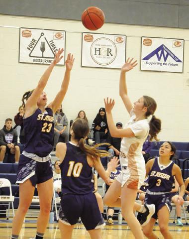 CALDWEL L ’ S LYDIA HICKS takes a shot over a couple of St. Joseph defenders during the Caldwell-St. Jo’s game last Friday. Tribune photo by Denise Squier