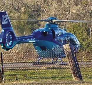 A HELICOPTER lands at the scene of this two-vehicle fatal accident on Wednesday, March 5, on State Highway 21 East.