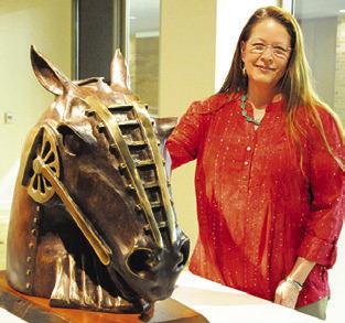 LOCAL ARTIST and art teacher Clover Cochran poses with one of her pieces of bronze work on display in the “Practice What We Teach” exhibit at the Reynolds Gallery at the Memorial Student Center at Texas A&amp;M.
