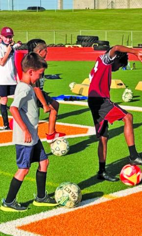 ATHLETES ATTENDING Hornet Soccer Camp work on their footwork skills.