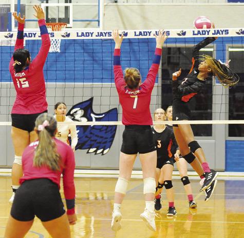 SOMERVILLE’S KARYS ELLIS gets a kill by hitting the ball between Snook’s Karla Lara and Kiley Price during a district volleyball match in October 2024 in Snook. Tribune photo by Denise Squier
