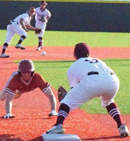 CALDWELL’S BRYCE BLINKA attempts to steal third base, trying to beat the throw by the Troy shortstop during the Hornets’ playoff series against the Trojans. -- Tribune photo by Denise Squier