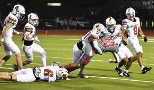 KYSON STRANGE AND Gus Naquin make a tackle in the season finale against Bellville. Tribune photo by Roy Sanders