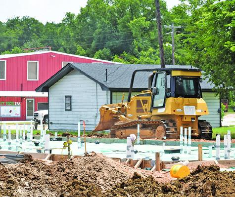 A CONSTRUCTION CREW works at the new Taco Bell location off State Highway 21 West.