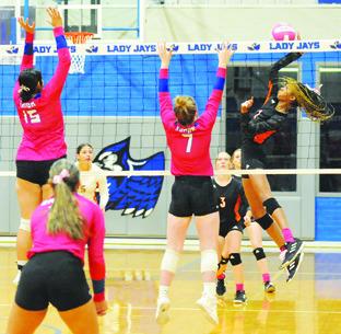 SOMERVILLE’S KARYS ELLIS gets a kill by hitting the ball between Snook’s Karla Lara and Kiley Price last Tuesday. Tribune photo by Denise Squier
