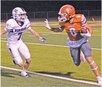 JAMIN WHITE CARRIES the ball after a reception against Robinson.