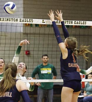 LUCY FERGUSON goes up to block the ball with the Lady Hornets ready on defense. Photo courtesy of Casey Faske