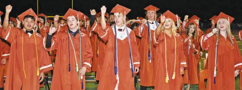 CALDWELL HIGH SCHOOL GRADUATES sing the school song at the Friday commencement.