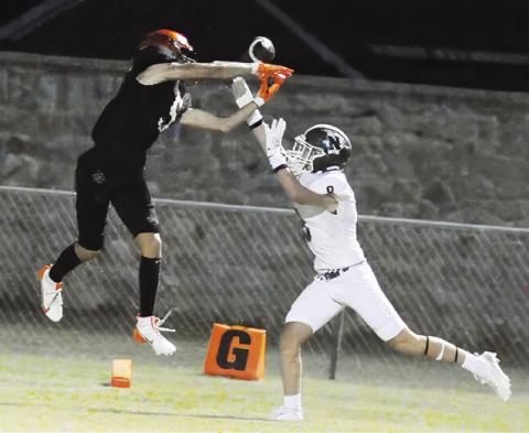 SOMERVILLE’S KYLE BROOKS reaches for this pass as this Normangee player defends. The Yeguas won 21-0 in their opener. Tribune photo by Denise Squier