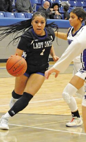 ALANA STRINGFELLOW drives the ball toward the basket during the Snook-Mumford game last Friday night in Mumford. Tribune photo by Denise Squier