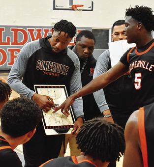 TERRANCE PRESTON, Somerville’s new head basketball coach, talks to his players during a timeout in the Caldwell game.