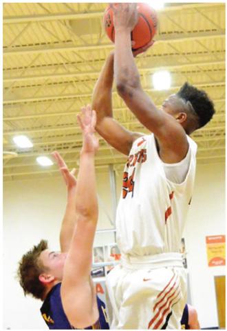 CALDWELL’S JUNIOR Mathis reaches high for this shot last week against La Grange. The Hornets won 48-45 in Caldwell.