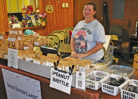 CHRISTY GRASSL OF Sweet Kitten Candy is at her display booth on Saturday, March 29, at the Chriesman Craft &amp; Yard Sale at the Chriesman Community Center. The event drew several vendors.