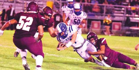 SNOOK QUARTERBACK GARRETT LERO fights for yardage during Friday night’s 22-7 win over Milano. Lero ran for 94 yards and threw for 131 yards in the win. The Bluejays are hosting Iola this Friday night at 7 p.m. at Bluejay Stadium. -- Tribune photo by Denise Hornaday