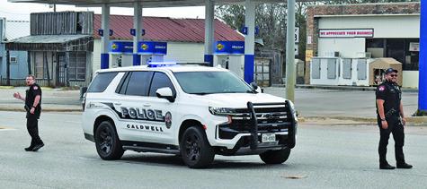 CALDWELL POLICE DIRECT traffic at the Main Street and State Highway 21 stop light on Monday during the power outage.