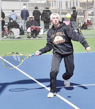 TILLY HICKS PREPARES to return the ball during a girls’ doubles match at the Caldwell Tennis Tournament. -- Tribune photo by Roy Sanders