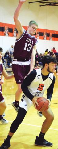 SOMERVILLE’S JULIAN Frayre looks to pass while Iola’s Brian Crosby jumps to defend.