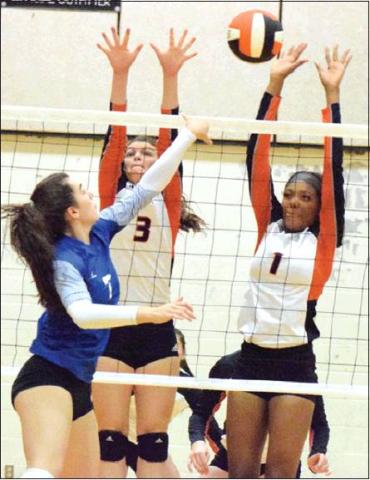 SNOOK’S NATALIE VACHA tries to hit the ball past Somerville’s Emma Kovasovic and Xadria Martin during last Tuesday night’s Snook-Somerville district match. -- Tribune photo by Denise Hornaday