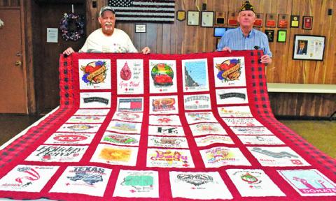SHERWOOD LUCKO JOINS Franklin Karasek in displaying this quilt representing T-shirts he has earned through the years as an American Red Cross blood donor. See story inside.