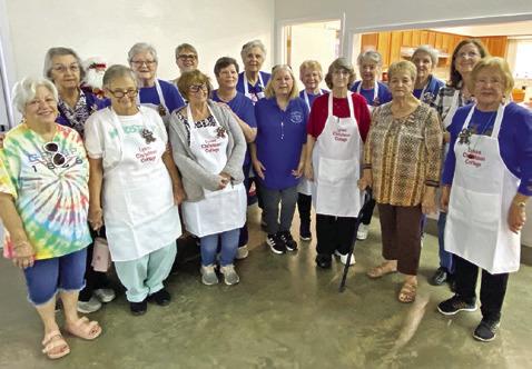 VOLUNTEERS FOR THE Christmas Cottage event pose for a group photo. This annual event was hosted by the Lyons Education Extension Association on Nov. 7 and 8. Complimentary gingerbread cookies and wassail were available for attendees. Photo courtesy of Lyons EEA