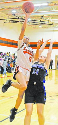 DESTINY VELA reaches for a layup during the Somerville-Mumford game last Friday night.