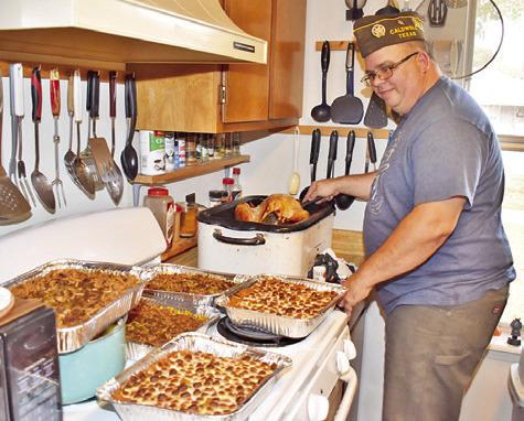DAVID PALICKA HELPS prepare a community Thanksgiving dinner on Thursday at Stone Street Retirement Complex. The dinner was prepared by In God’s Hands Ministry and was well attended.